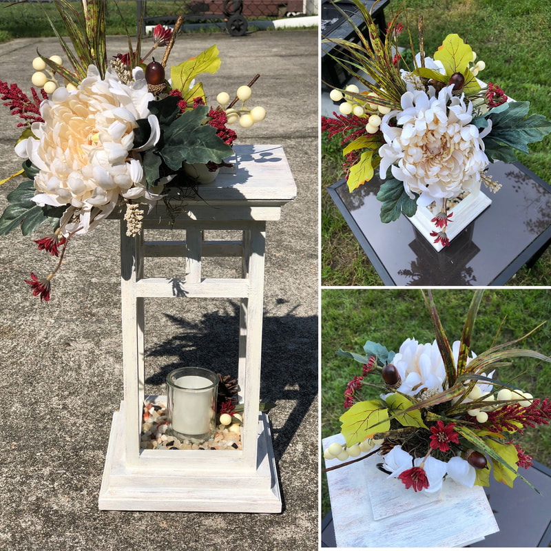 Handcrafted wood lantern with faux floral arrangements with pops of red.