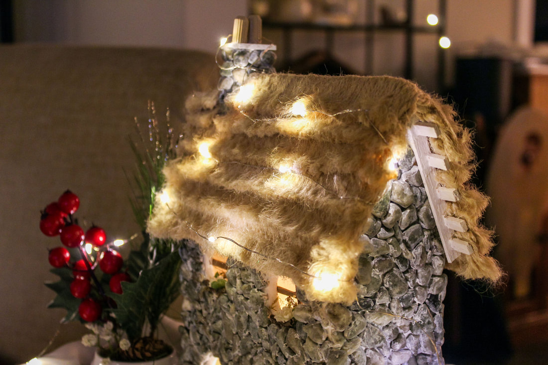 Fairy lights on the roof of a handcrafted fairy cottage.