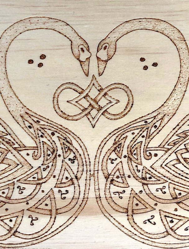 Hand drawn wood burned Celtic inspired swans.