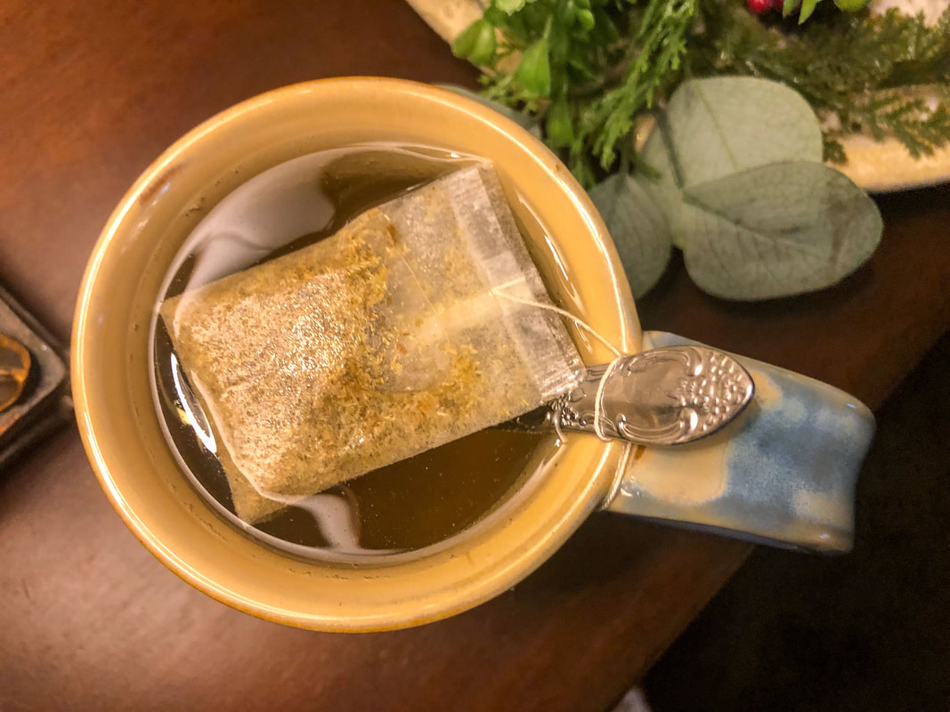 Tea cup with chamomile tea bag for reducing stress.