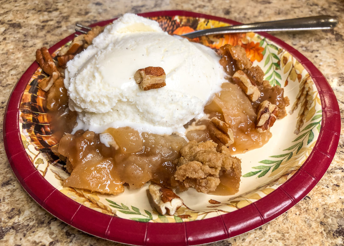 Apple crumble dessert with vanilla ice cream.