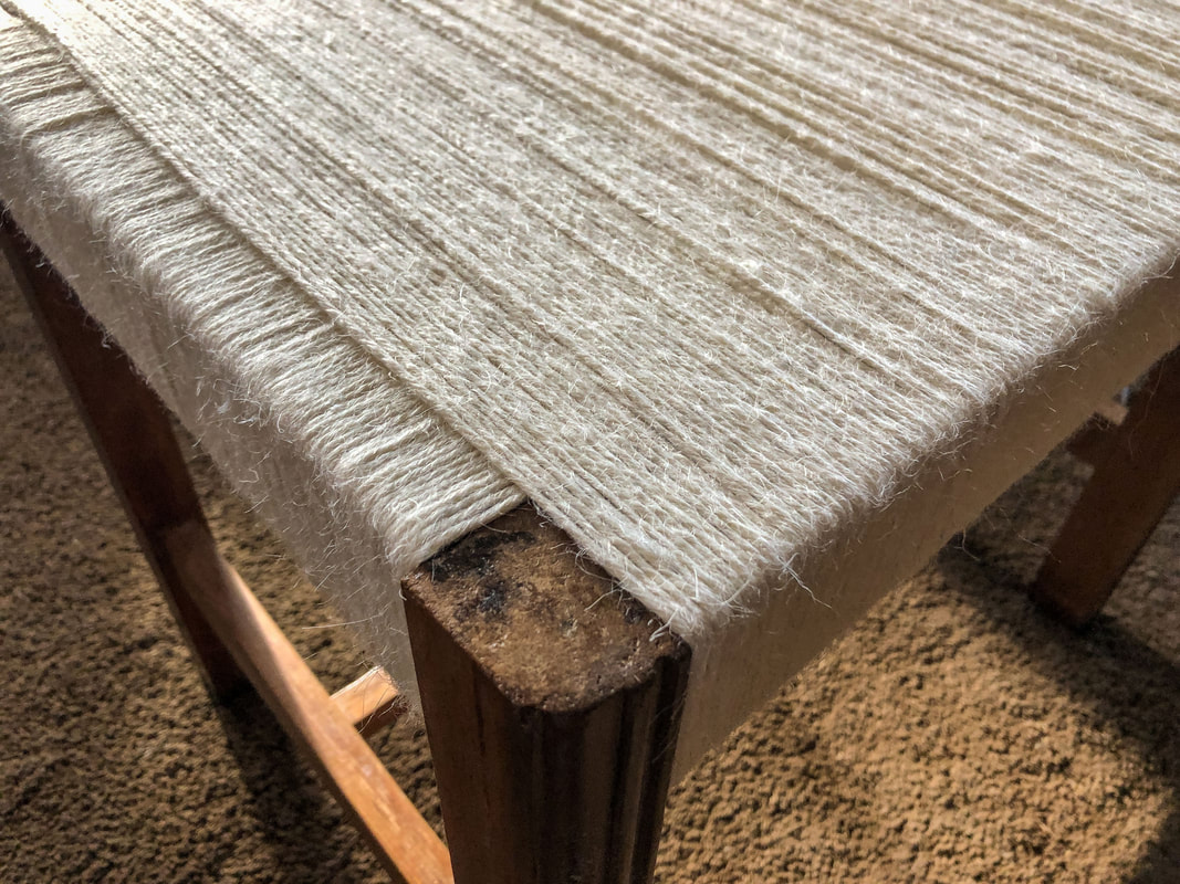 Closeup of a repurposed stool that has been wrapped in jute twine.