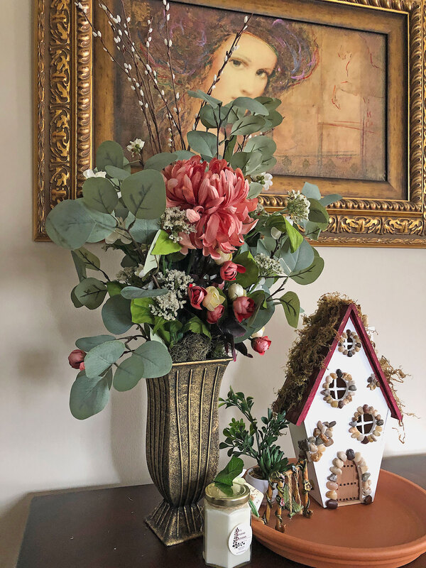 Thrifted vase with faux floral arrangement in vignette.