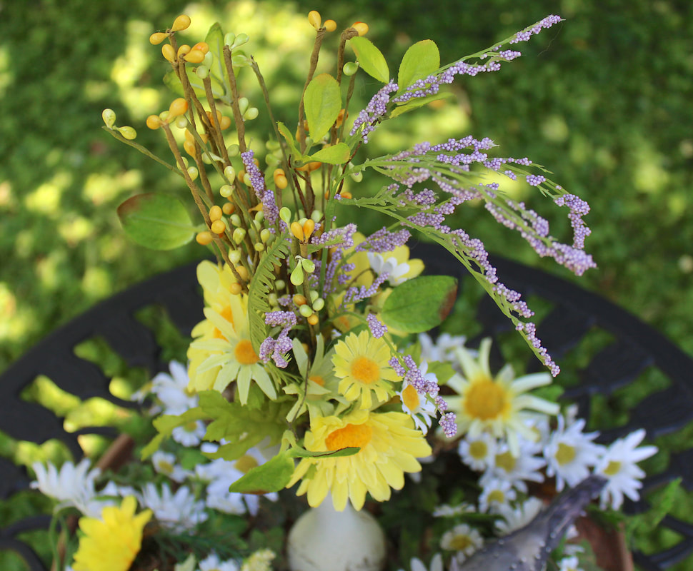 Faux florals and pip berries in a spring themed floral arrangement 