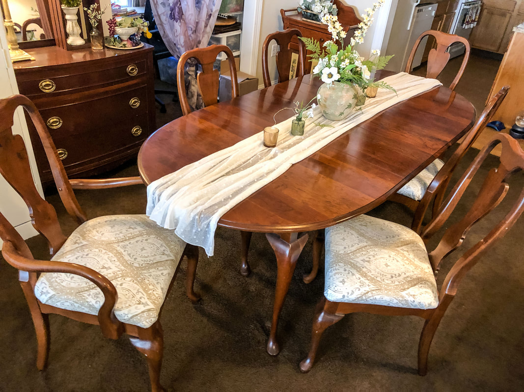 Dining room chairs after a DIY reupholstering project.