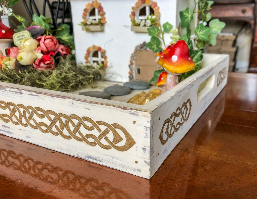 Closeup of DIY tray with painted Celtic knot border.