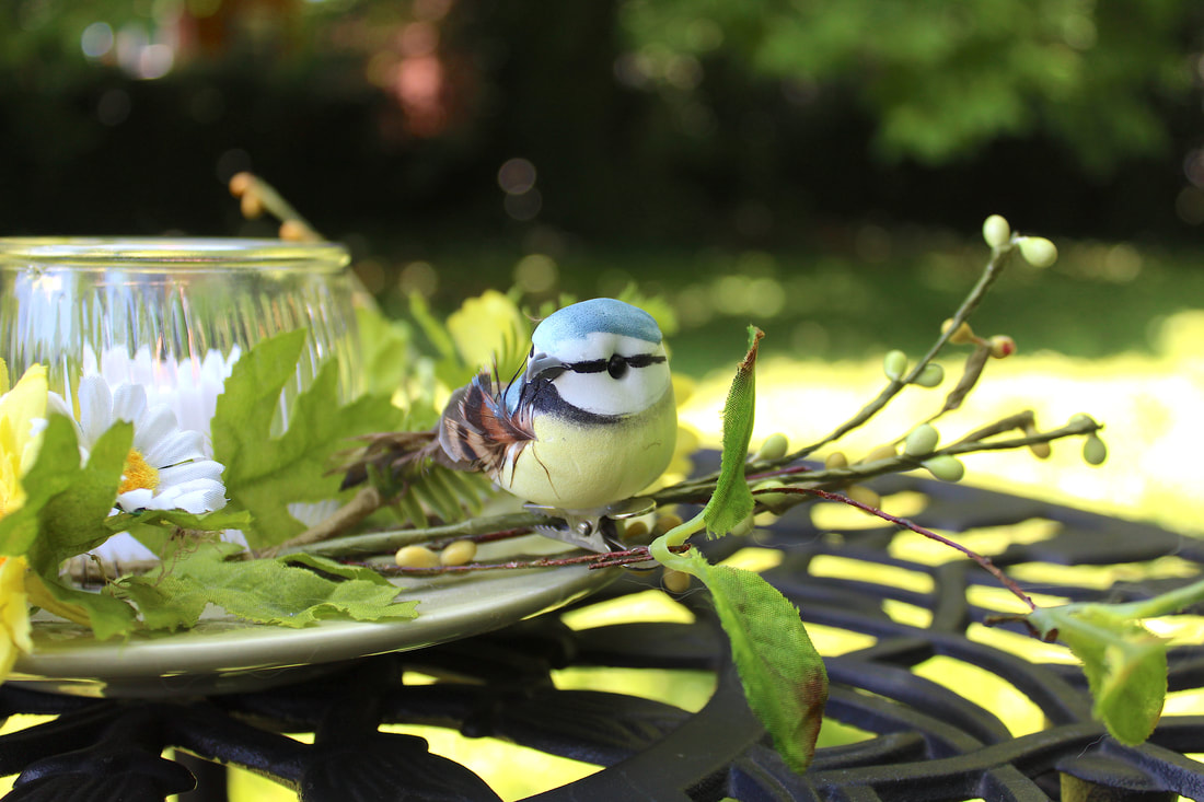 Faux florals with bird.