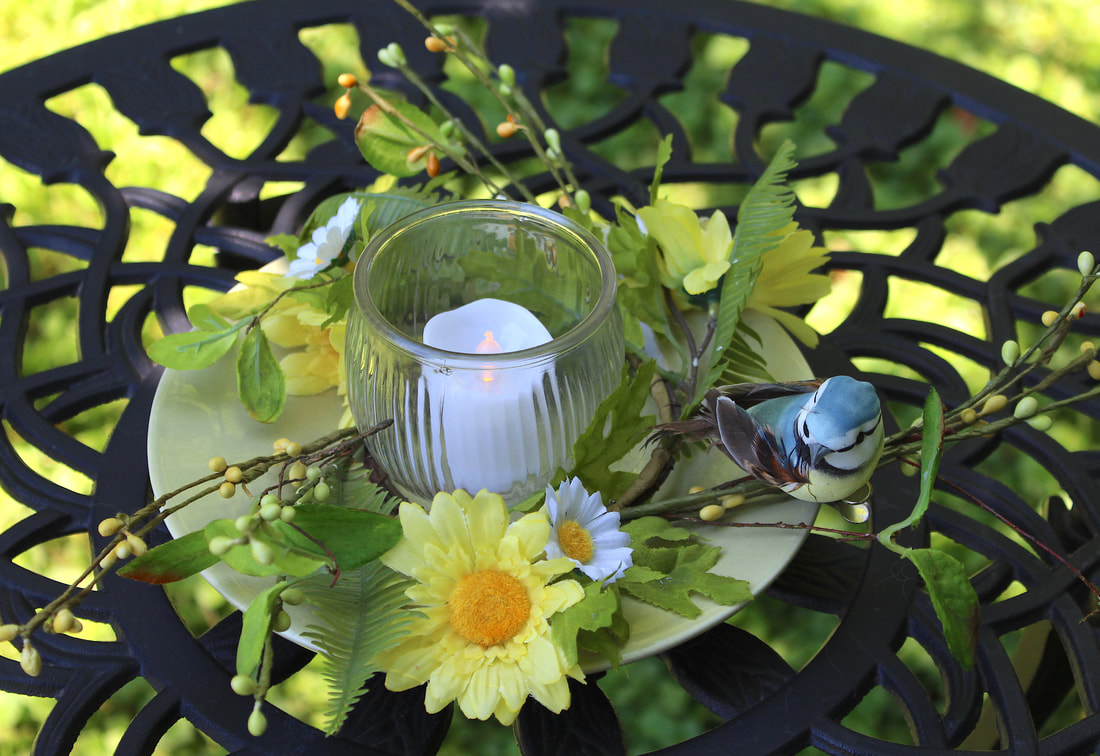 DIY candleholder with faux florals, bird and repurposed plate and glass.