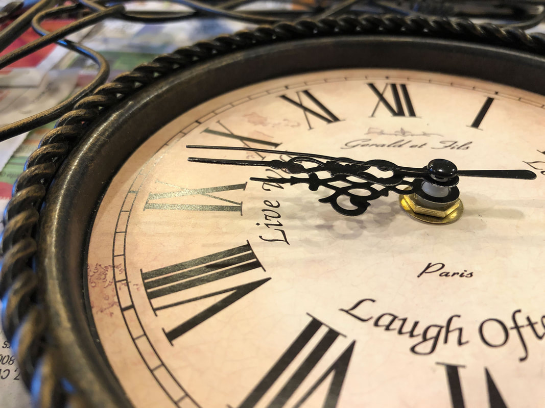 Closeup of clock face of a wire metal clock.