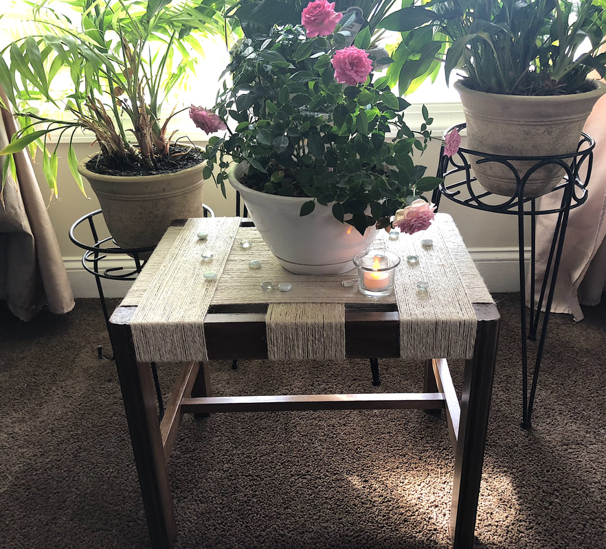 Repurposed vintage foot stool wrapped in jute twine.